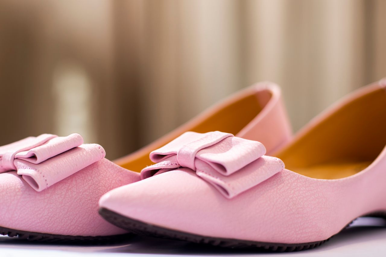 Mastering the First Impression: Your intriguing post title goes here Elegant pink leather shoes with decorative bows in a fashionable close-up shot.